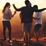 Teens - Four Person Standing at Top of Grassy Mountain