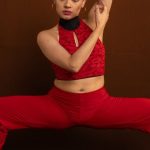 Fashion Shows - A Woman Wearing a Red Outfit Doing a Dance Pose