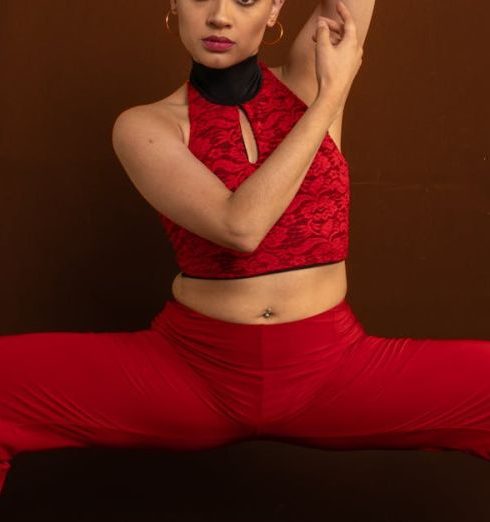 Fashion Shows - A Woman Wearing a Red Outfit Doing a Dance Pose