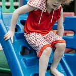 Kids Activities - Blonde Boy in Red T-Shirt Playing on Slide