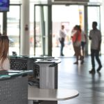 Customer Service - White Sitting Behind Counter Under Television