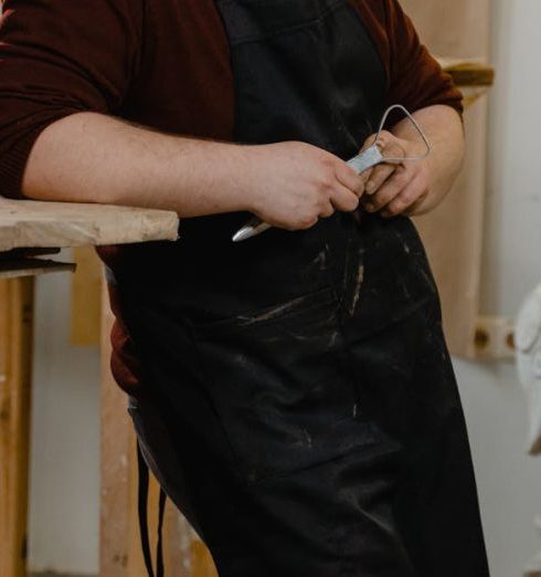 Art Installations - A Man Standing Beside a Clay Sculpture