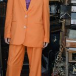 Sustainable Shopping - Photo of a Woman Wearing an Orange Suit