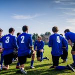 Team Sports - Group of Sports Player Kneeling on Field