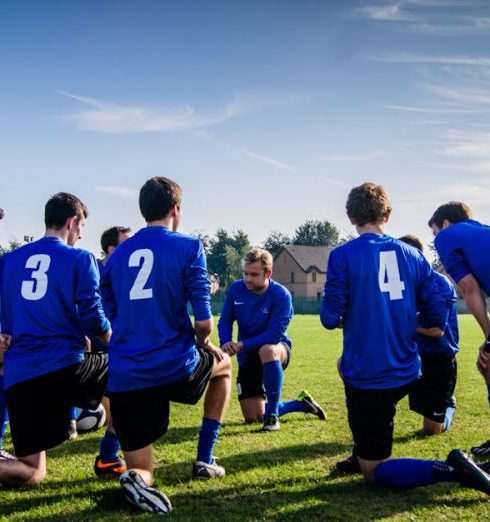 Team Sports - Group of Sports Player Kneeling on Field