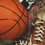 Sports Apparel - Sneakers, a Basketball and an Analog Camera Lying on an Old Rug