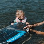 Kids' Sporting Goods - Father and daughter Smiling to Each Other in Water