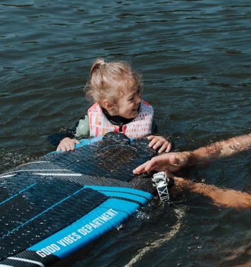 Kids' Sporting Goods - Father and daughter Smiling to Each Other in Water