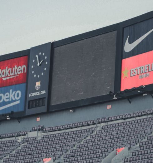 Sports Brands - Signage in Stadium Under White Sky