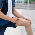 Fitness Accessories - Man stretching on a Wooden Platform