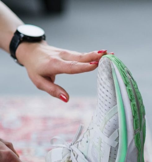 CrossFit Gear - Person Sitting on a Carpet Doing Foot Stretching