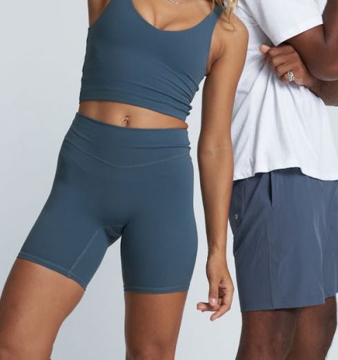 Team Sports Apparel - Woman and Man Posing in Gym Clothing