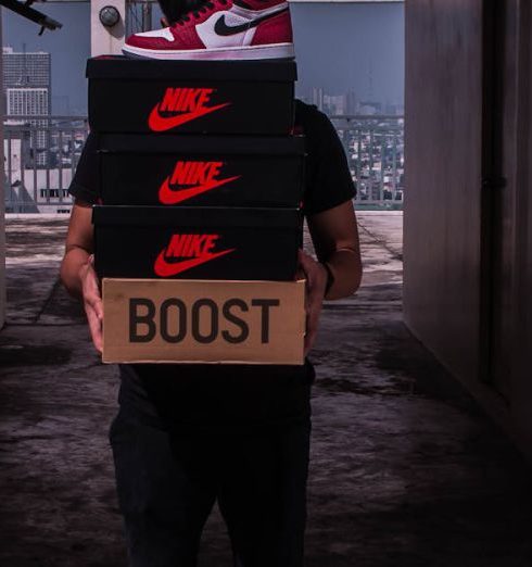 New Brands - Person Carries Boxes of Shoes