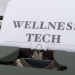 Fitness Trackers - A typewriter with the word wellness tech on it