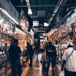 Grocery Stores - A Person in White Shirt Standing in Front of Store