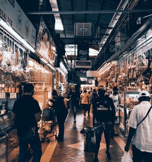 Grocery Stores - A Person in White Shirt Standing in Front of Store