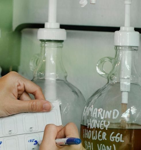 Zero-Waste Stores - Close-up of a Person Writing in a Calendar in a Store with Beauty Products