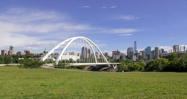 a-large-glass-building-with-a-city-in-the-background