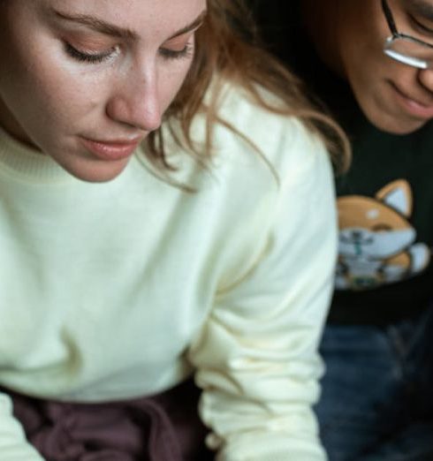 Expectations - Couple sitting together, examining a pregnancy test result with anticipation.