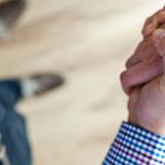 Trust - Close-up of a handshake between two people inside an office, symbolizing trust and cooperation.