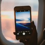 Windows - Person Holding Smartphone Inside Airplane