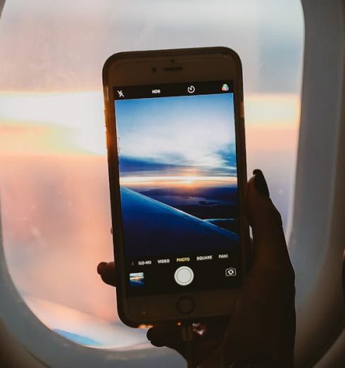 Windows - Person Holding Smartphone Inside Airplane