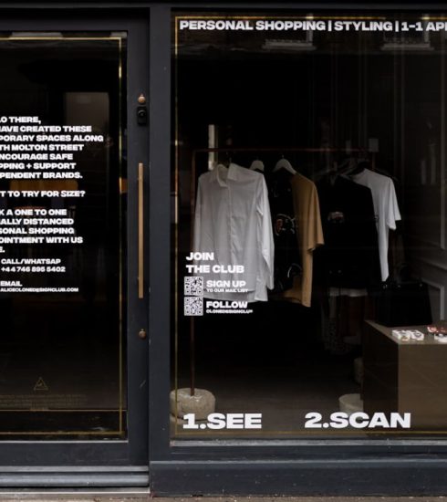 Omnichannel - white dress shirt hanging on brown wooden cabinet