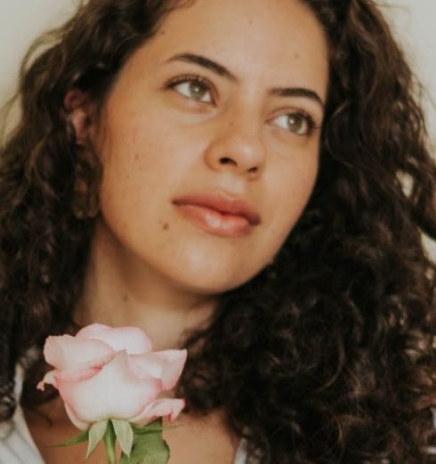 Appreciation Programs - Portrait of Brunette Woman Holding Pink Rose