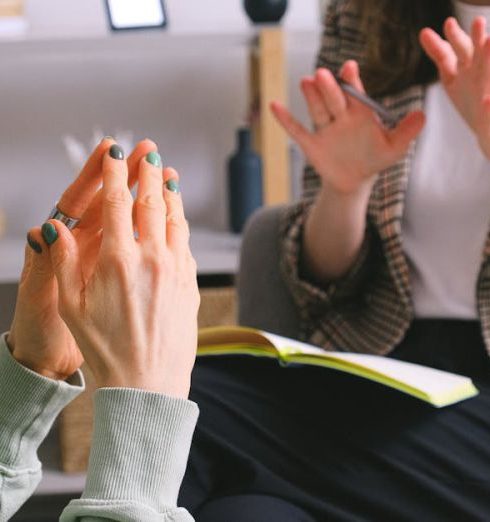 Resolution - Two women engaged in a therapy session, communication and support in an office setting.