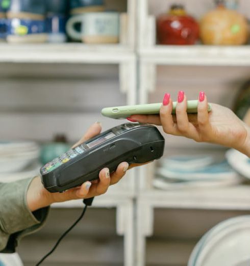 Mobile Commerce - A customer makes a cashless payment using a smartphone in a retail store. Modern technology meets convenience.