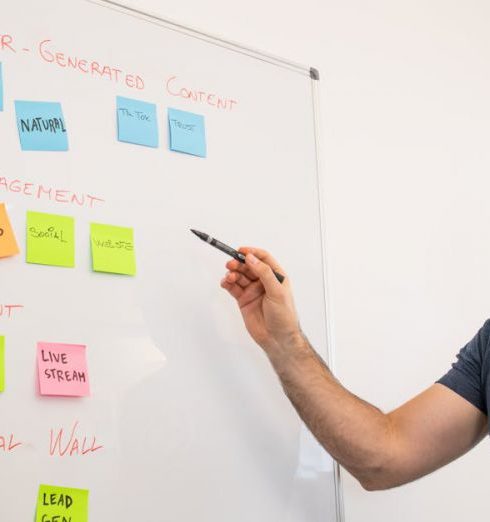 User-Generated Content - Smiling Man Standing by Whiteboard