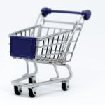 E-Commerce - A modern miniature shopping cart on a clean white background, perfect for e-commerce concepts.