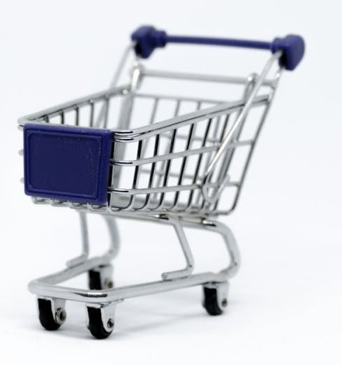 E-Commerce - A modern miniature shopping cart on a clean white background, perfect for e-commerce concepts.