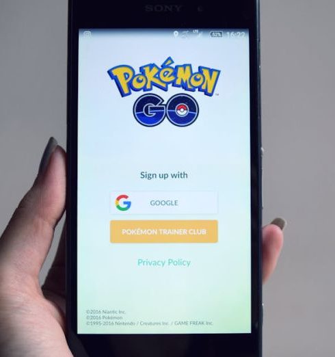 Augmented Reality - Smartphone displaying Pokémon Go app sign-in screen, held in hand.