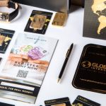 Order Value - Flat lay of promotional materials for gold investment, featuring brochures, cards, and gold bars.