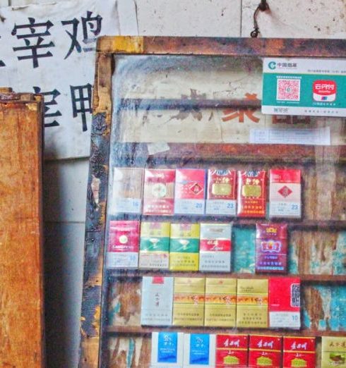 Product Descriptions - Vintage display of cigarette packs on an old wooden shelf, evoking a sense of nostalgia.