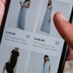 Product Images - A person browsing clothing options on a smartphone for online shopping.