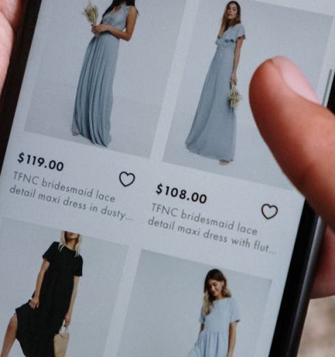 Product Images - A person browsing clothing options on a smartphone for online shopping.