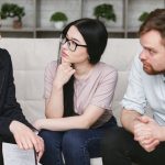 Customer Reviews - Three adults discussing business inside, focused on cooperation and strategy.