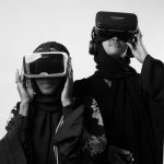 Gamification - Two women in traditional attire enjoying virtual reality, showcasing modern technology.