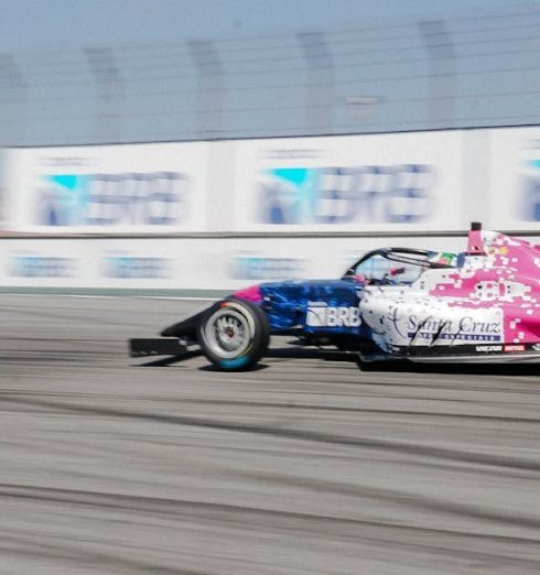 Qualifying Leads - F4 race car speeding on track with blurred motion capturing the essence of racing excitement.