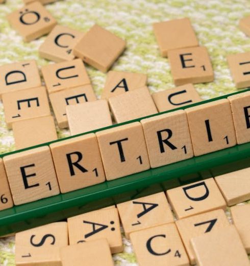 Sales Funnel - Close-up of Scrabble tiles spelling 'Vertrieb', showcasing language learning and play.