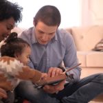 Storytelling - A diverse family enjoying storytime together, fostering love and learning indoors.