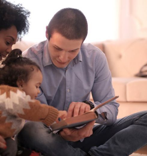 Storytelling - A diverse family enjoying storytime together, fostering love and learning indoors.