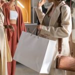 High-Value Customers - Three women enjoying a shopping experience in a stylish fashion studio.