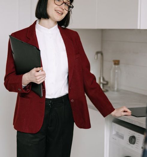 Sales Pitch - Real estate agent with clients in a modern kitchen during apartment viewing. Professional and engaging.