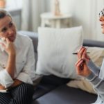 Behavioral Psychology - Two women engaged in a thoughtful counseling session in a cozy indoor setting.