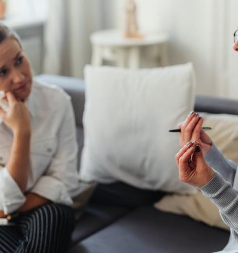 Behavioral Psychology - Two women engaged in a thoughtful counseling session in a cozy indoor setting.