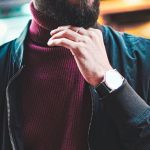 Portfolio - Portrait of a stylish man with glasses in an urban street setting, showcasing modern fashion.