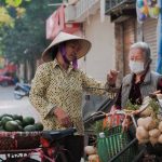 Commodities - Women Standing with a Bike with Vegetables